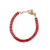 Bracelet femme doré serti de pierres rouges rectangulaires alignées avec fermoir ajustable et finition élégante.