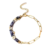 Bracelet en acier inoxydable doré pour femme avec chaîne à grands maillons, perles bleues et détails dorés au style élégant et moderne.