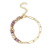 Bracelet en acier inoxydable doré pour femme avec chaîne à grands maillons, perles violettes et détails dorés au style élégant et moderne.