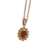 Collier doré pour femme avec pendentif composé d'une pierre rouge ovale entourée d'un halo de petites pierres scintillantes, au style élégant et raffiné.